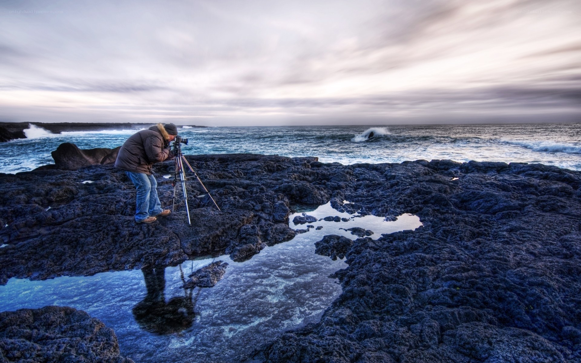 Photographer on rocky shore