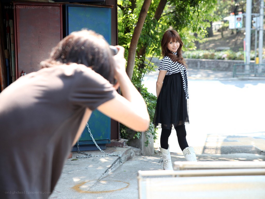 Photographer shooting a model outdoors