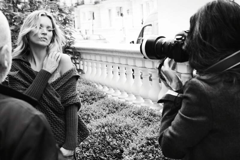 Photographer shooting model outdoors