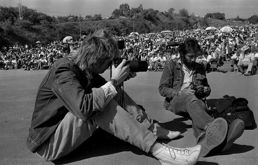 Photographers at a large outdoor event