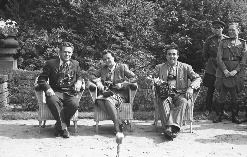 Photographers with cameras in garden