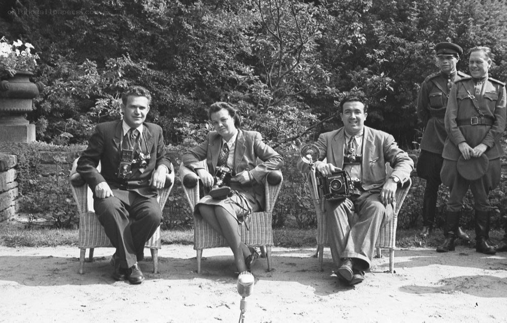 Photographers with cameras in garden