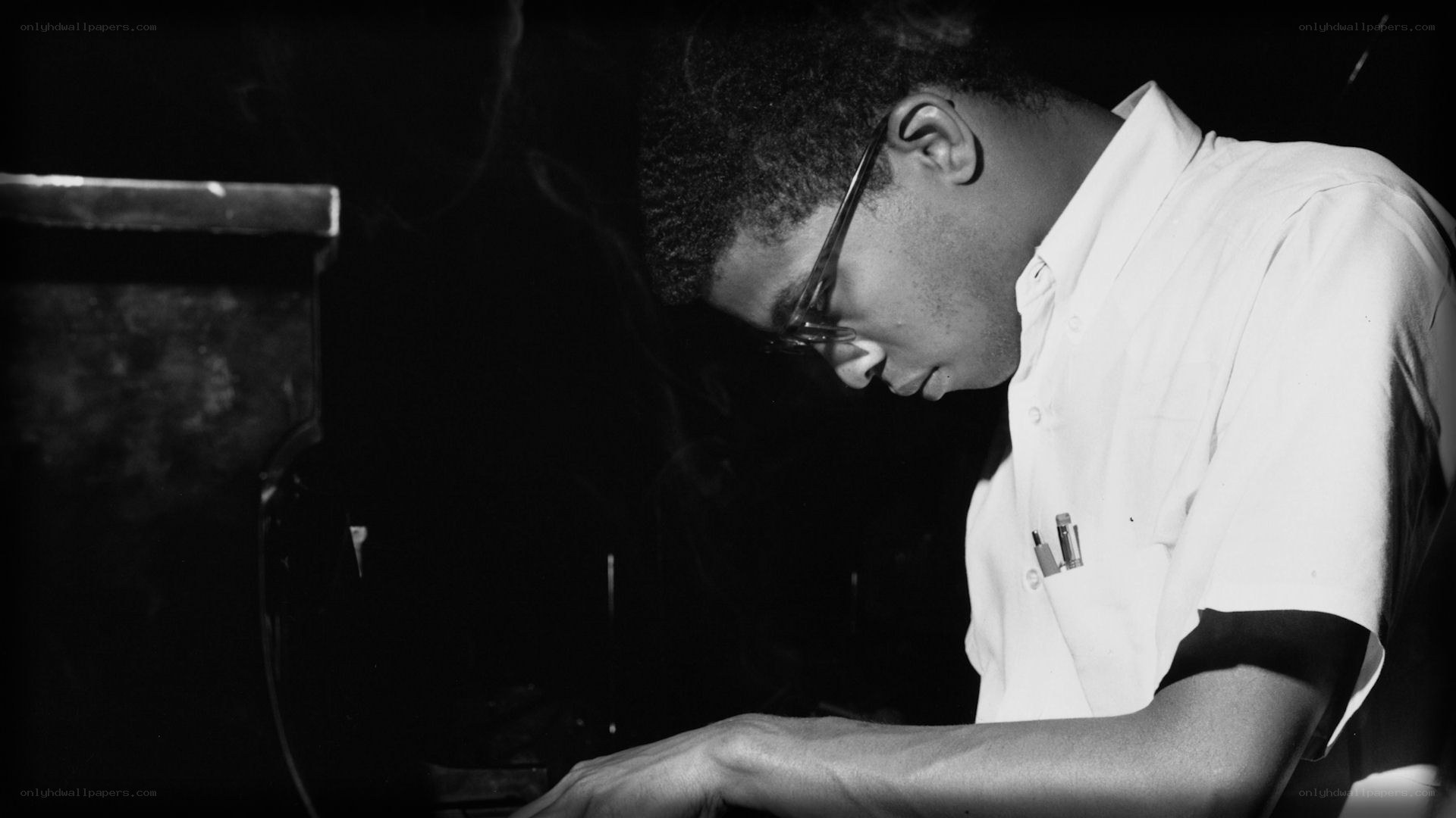 pianist playing in dim light