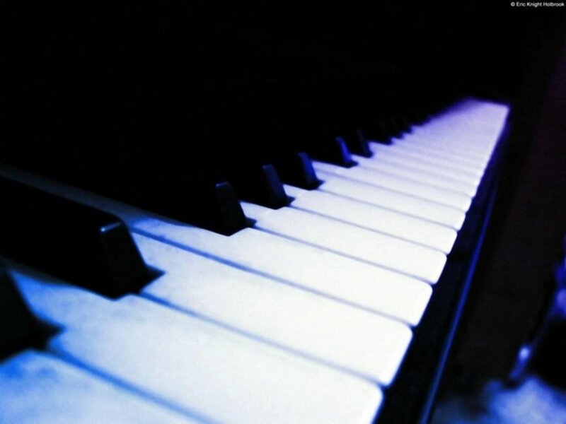 Piano keys under blue light