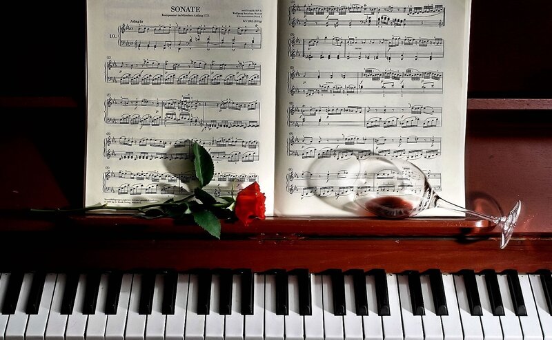 Piano sheet with rose and wine glass