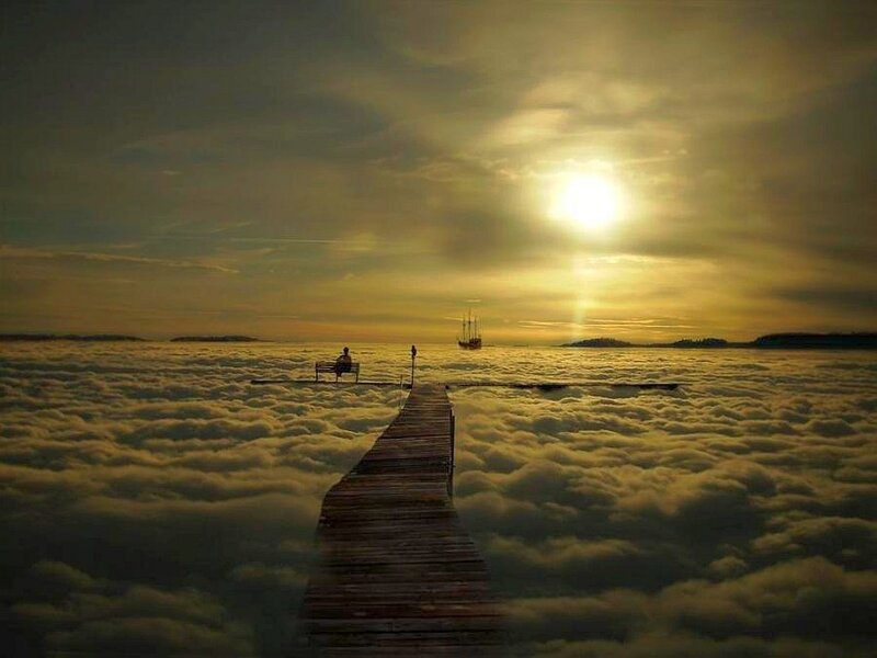 Pier above the clouds at sunset