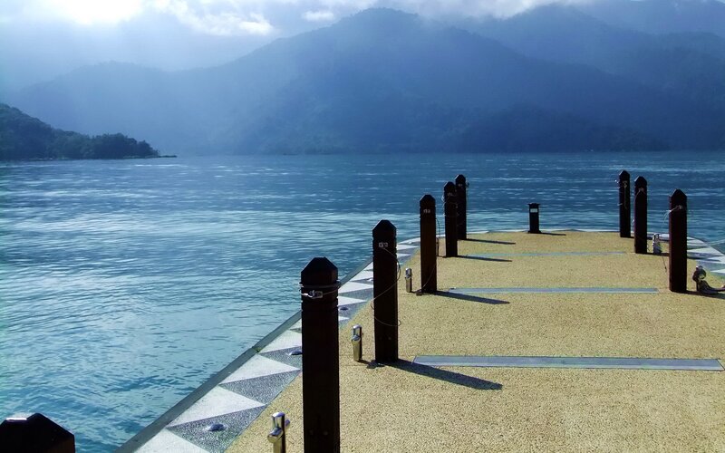 Pier at a lake with mountains