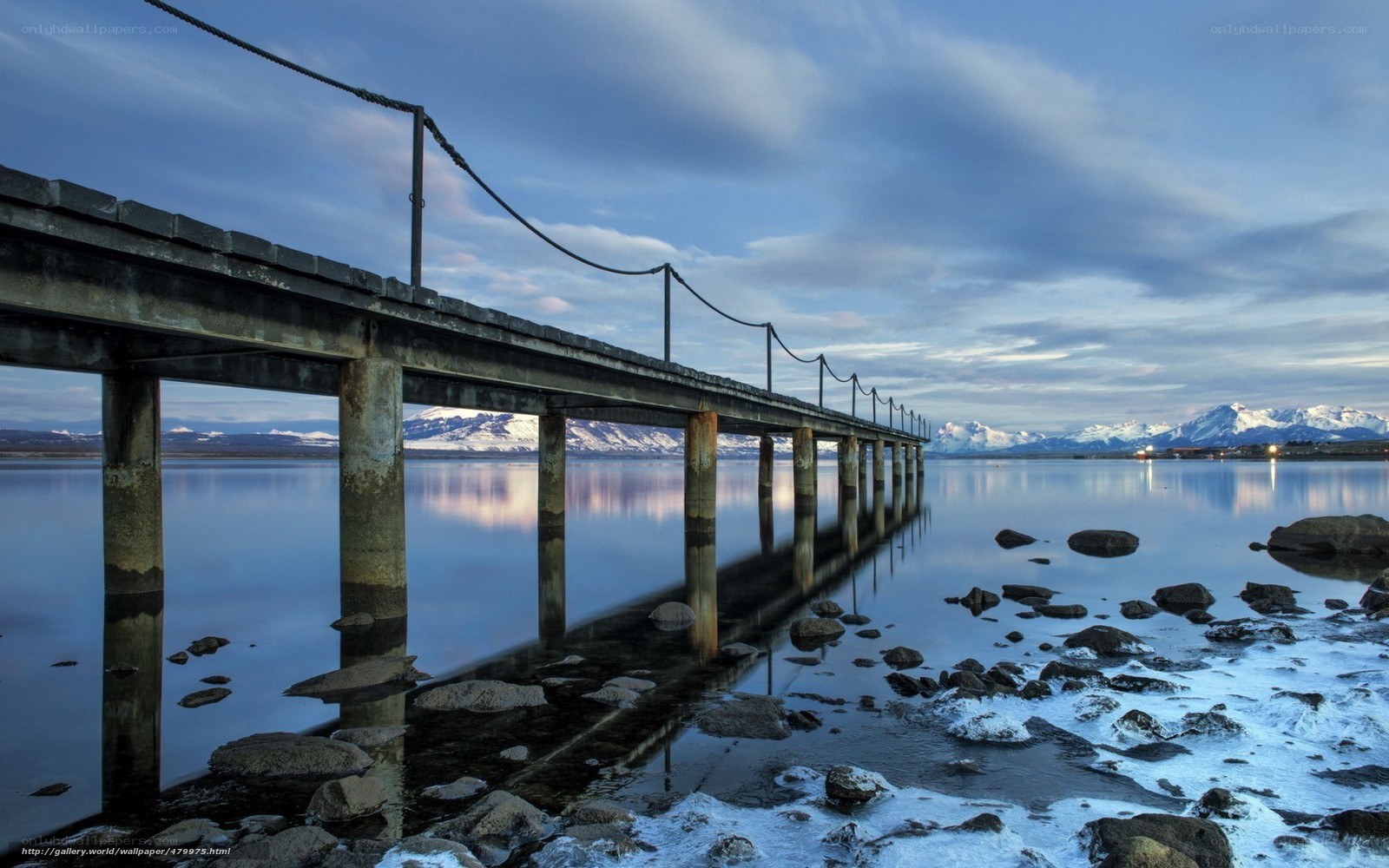 Pier at a lake with mountains