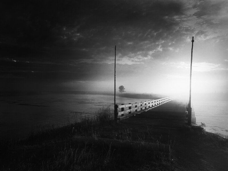 Pier at dawn in fog