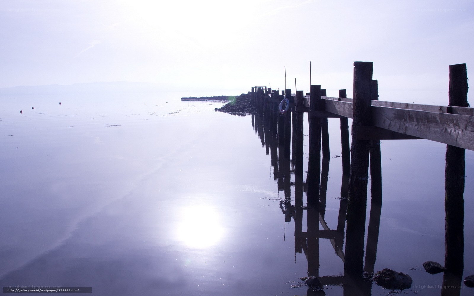 Pier at dawn on calm water