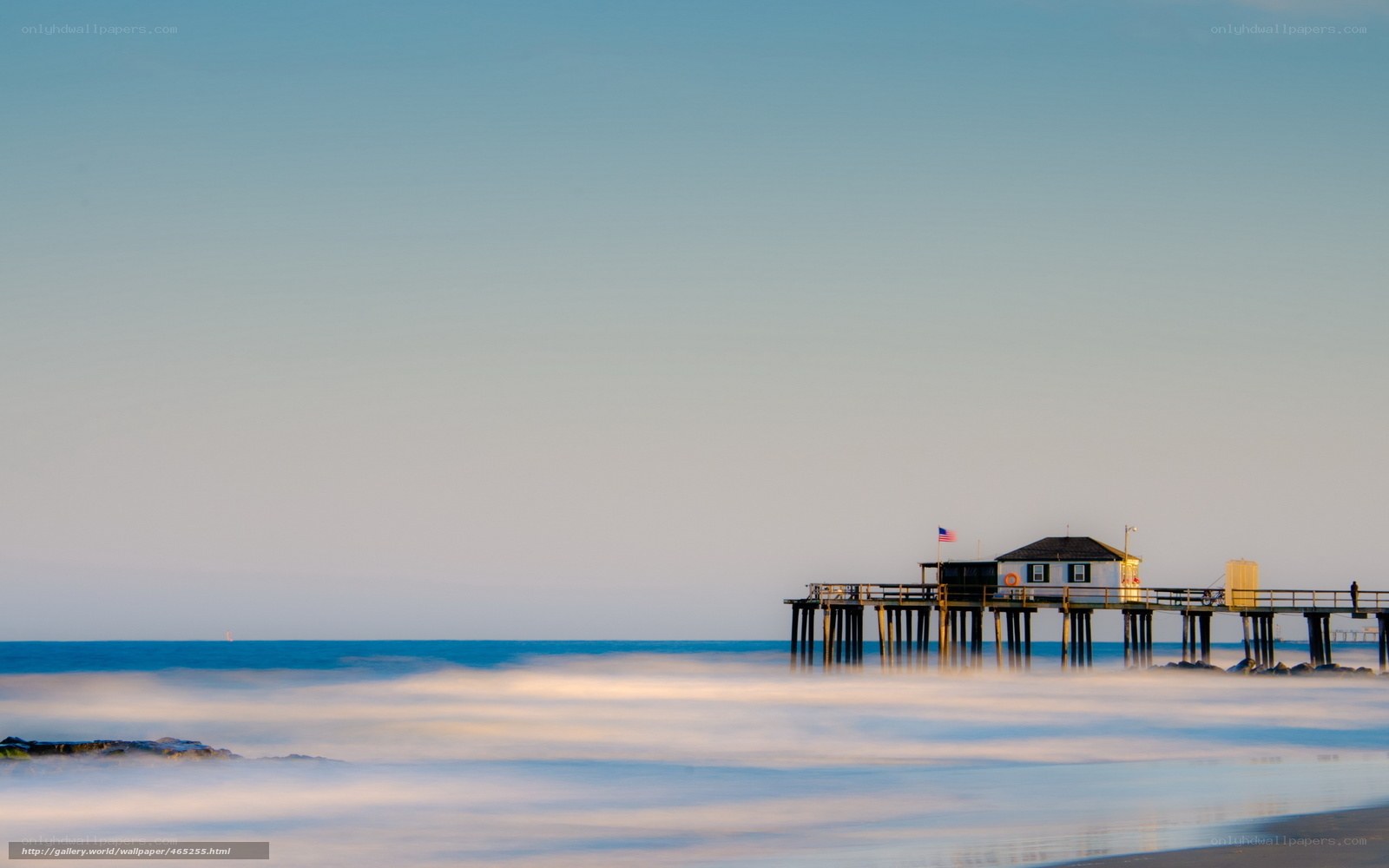 Pier at dawn with smooth waves