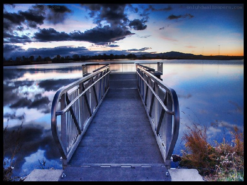 Pier at dusk over calm water