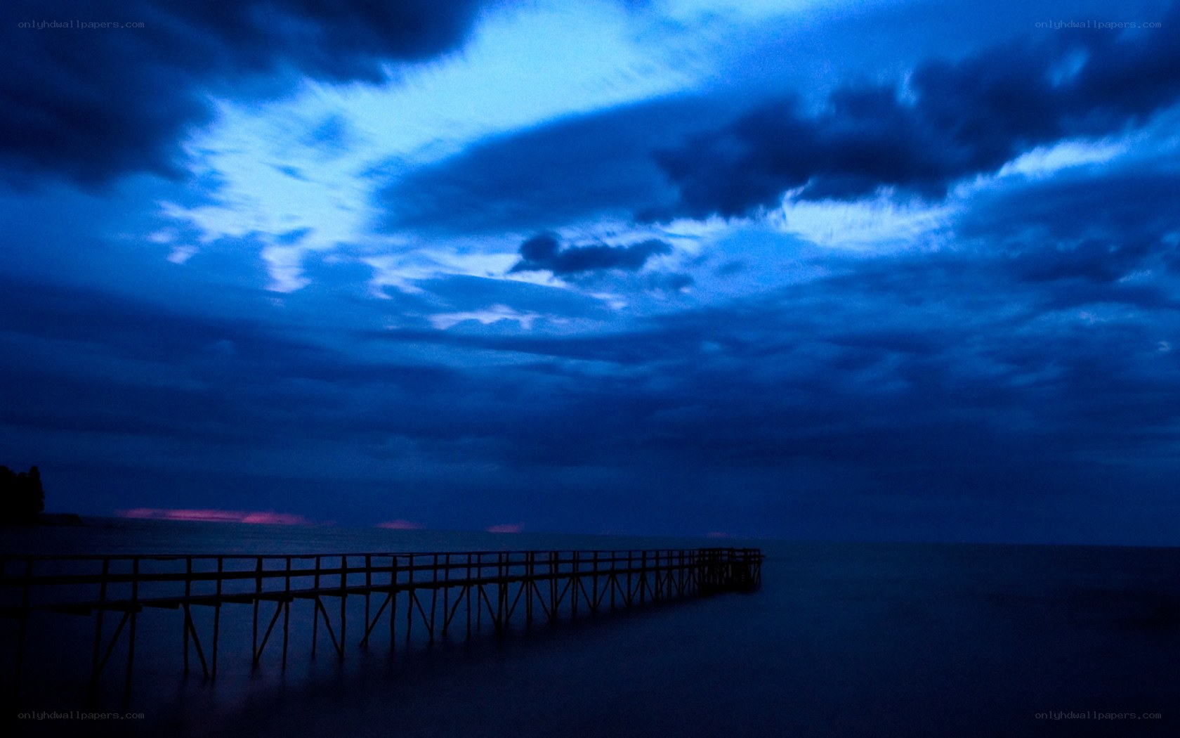 Pier at dusk with blue sky