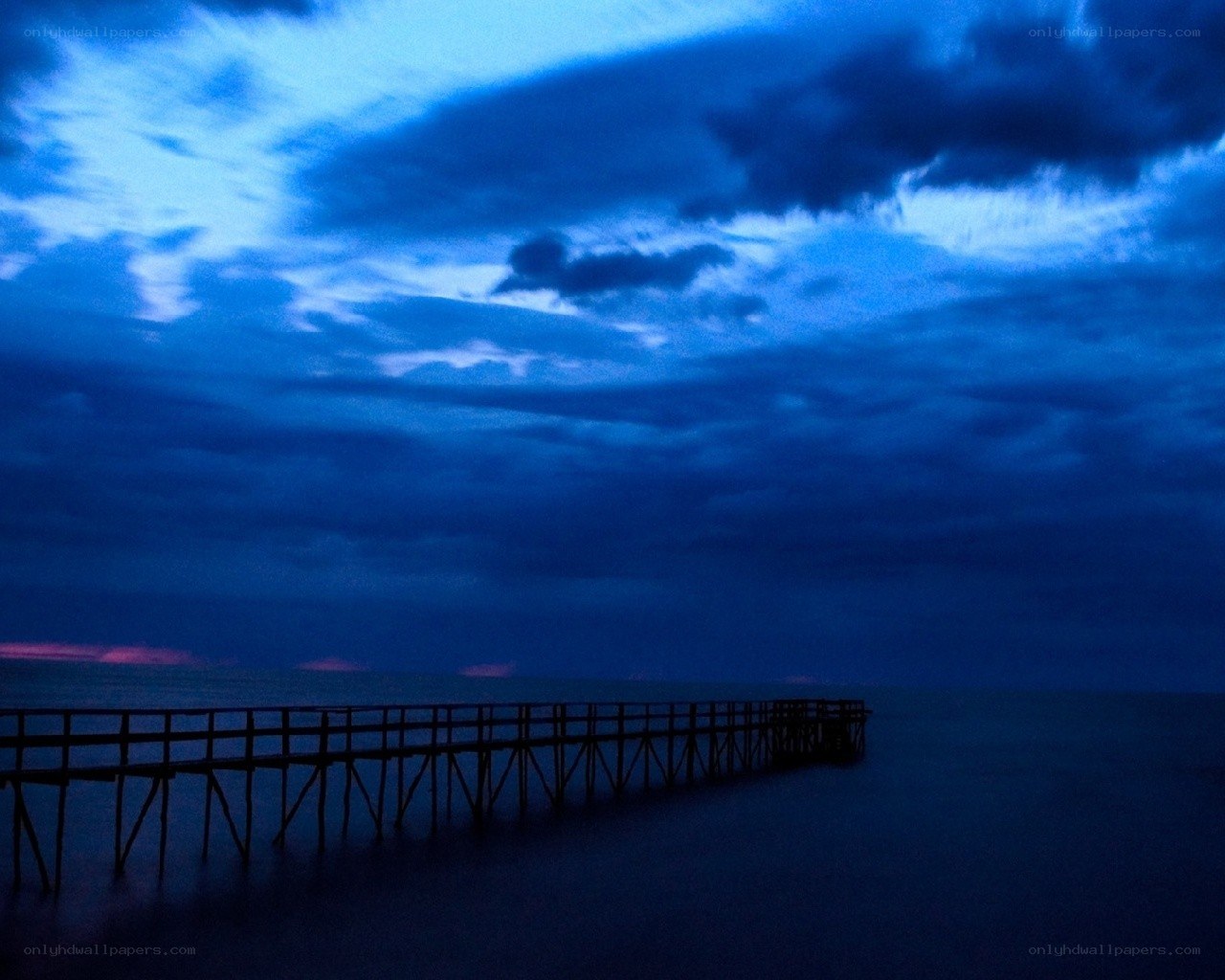 Pier at dusk with blue sky