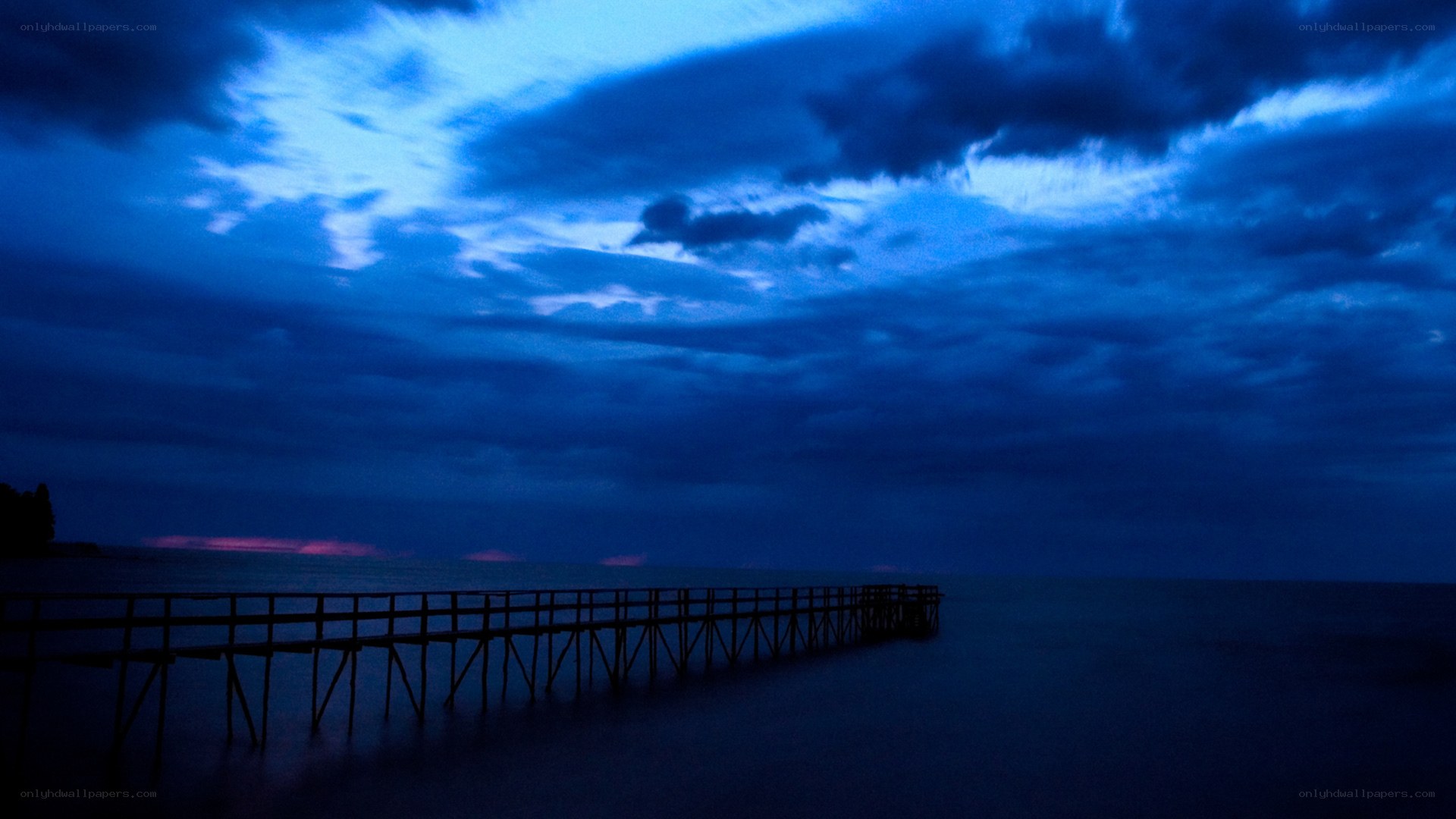 Pier at dusk with blue sky