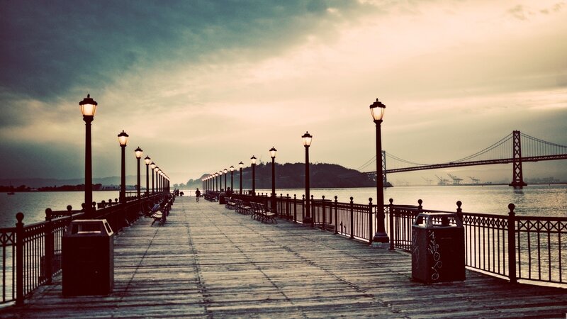 Pier at dusk with bridge