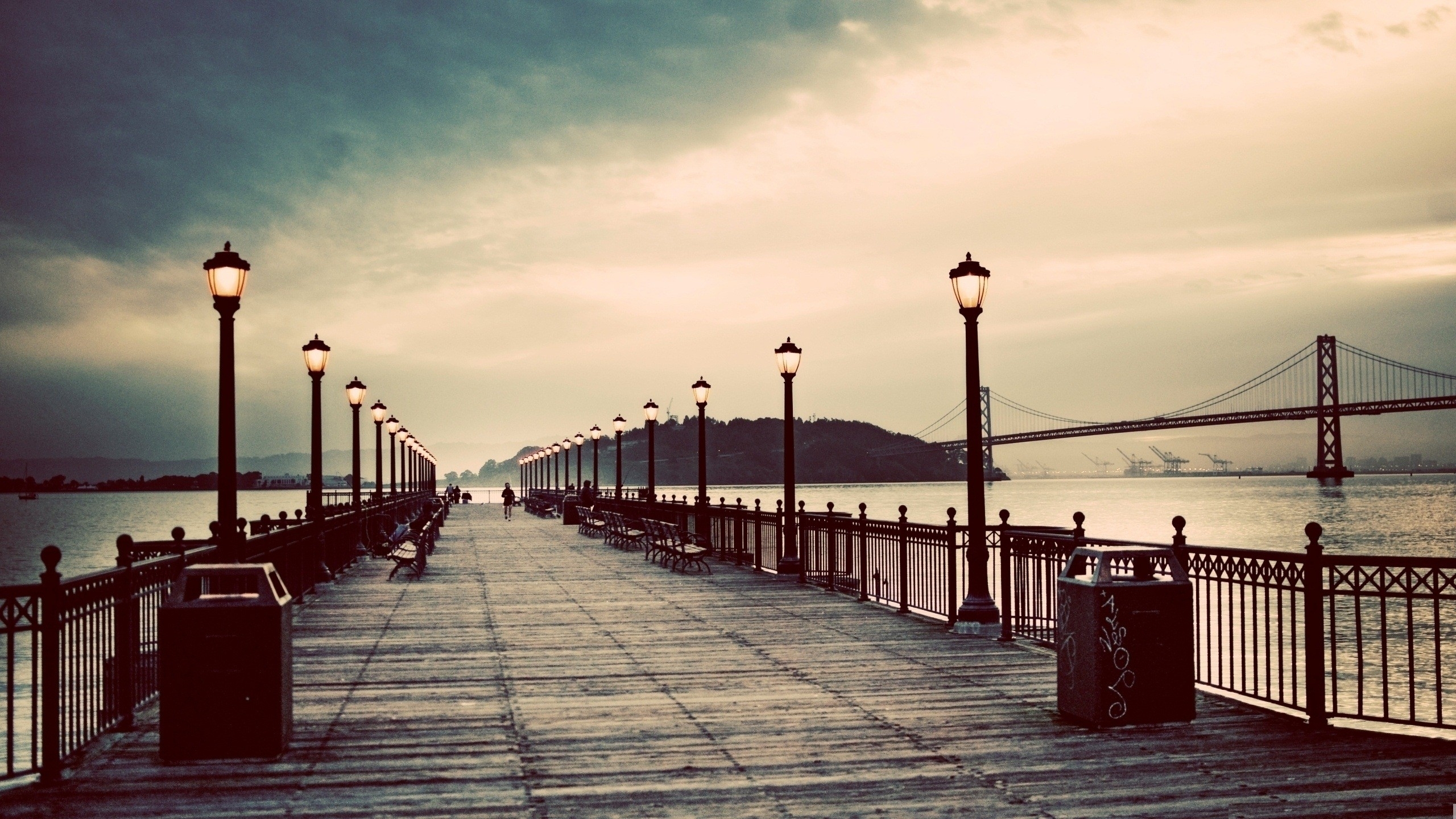 Pier at dusk with bridge