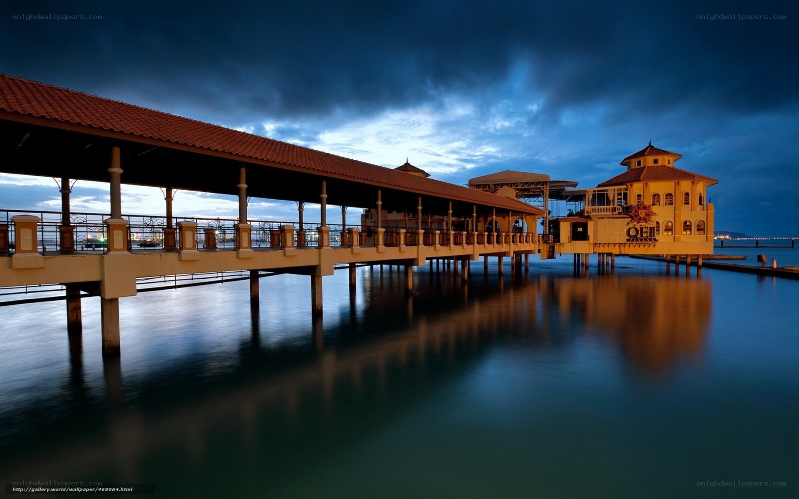 Pier at dusk with building