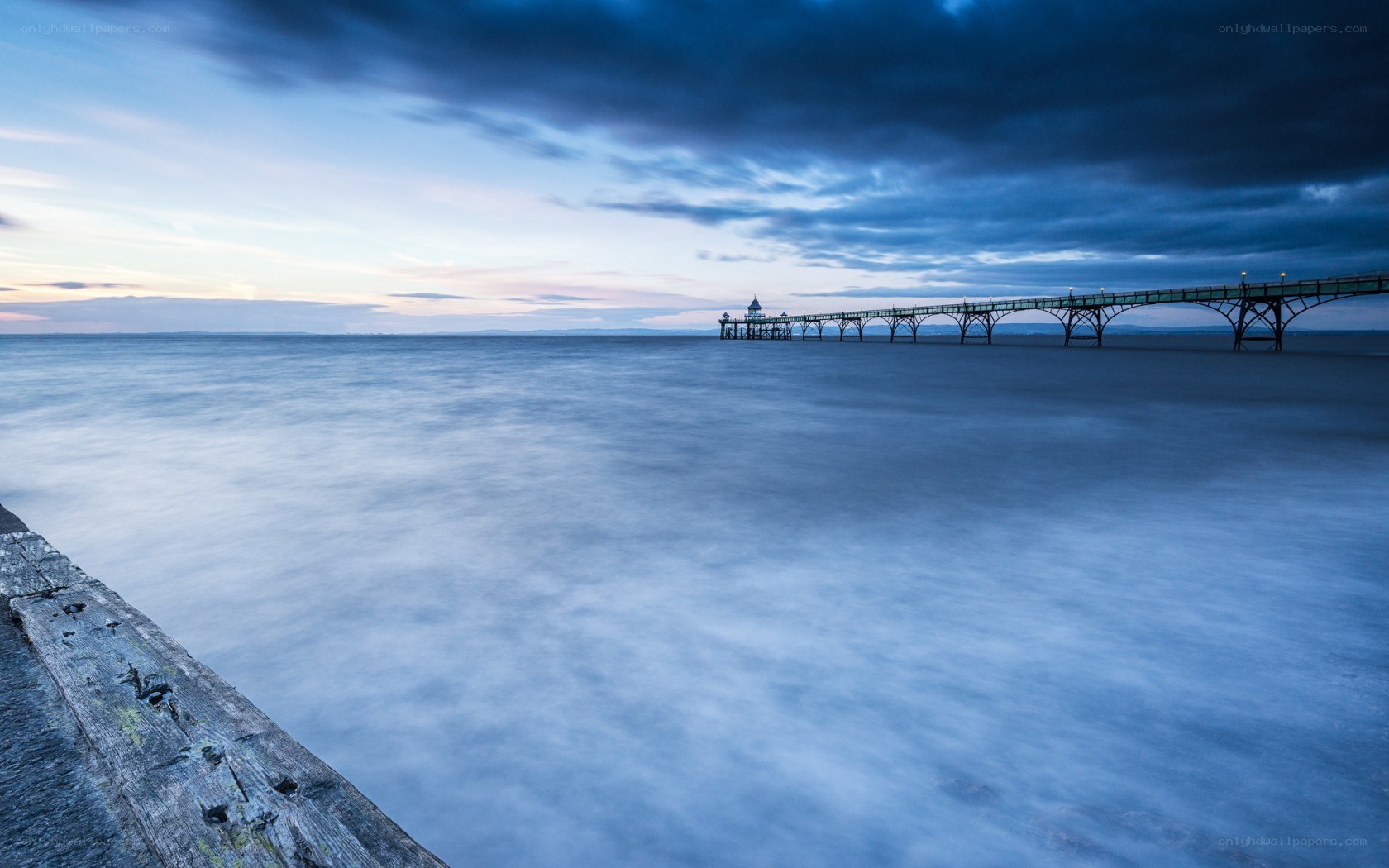 Pier at dusk with calm sea