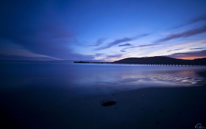 Pier at dusk with calm water