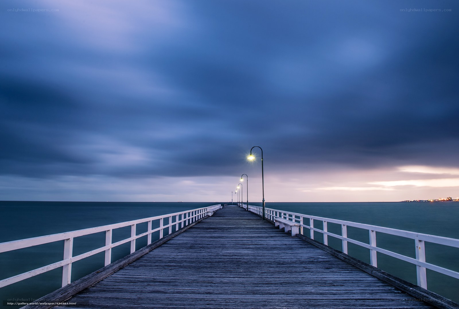 Pier at dusk with cloudy sky