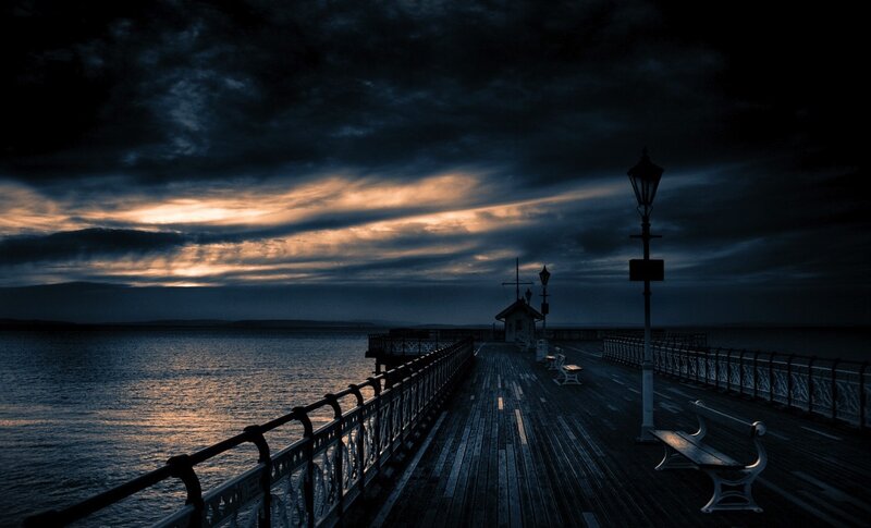 Pier at dusk with cloudy sky