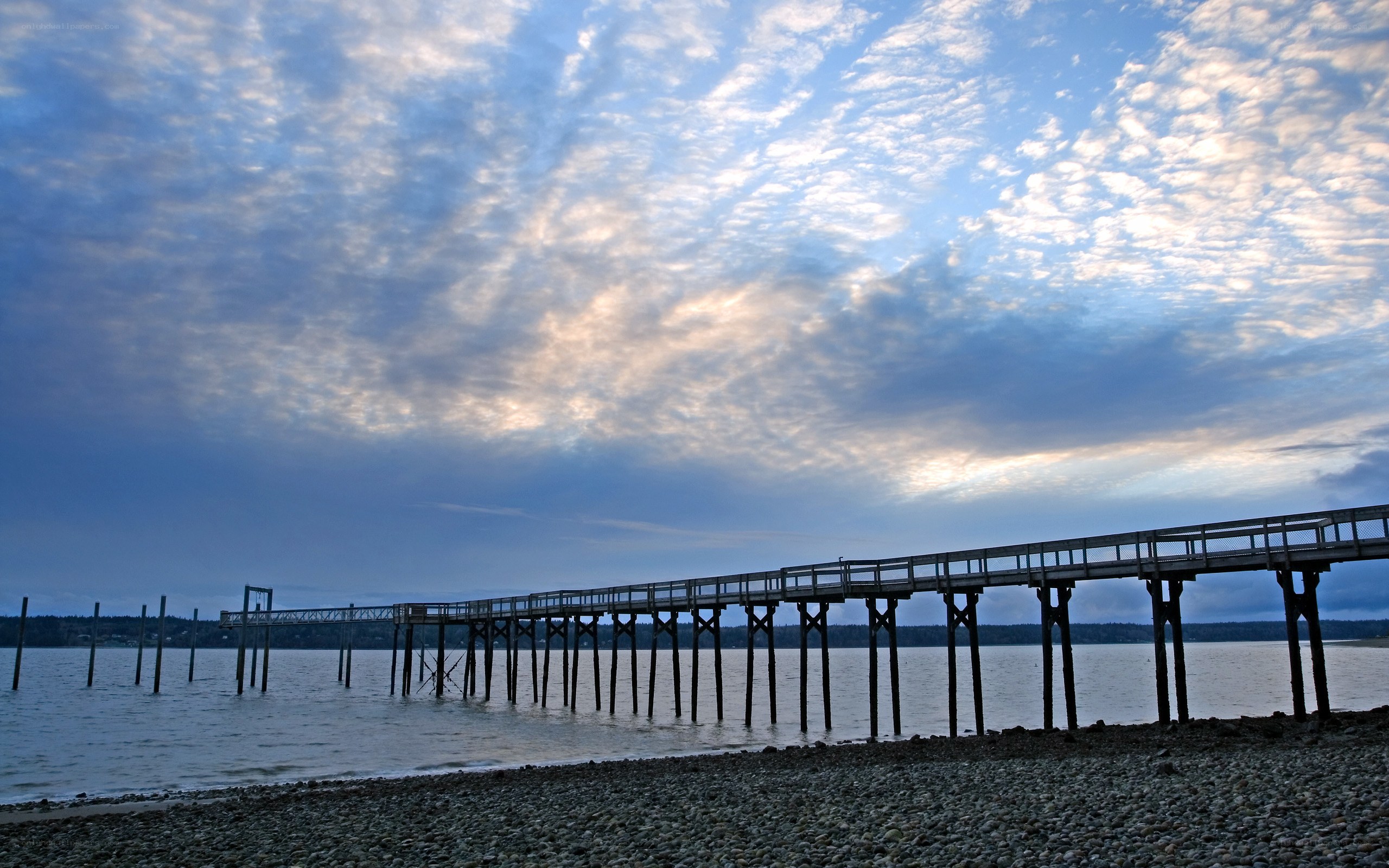 Pier at dusk with cloudy sky