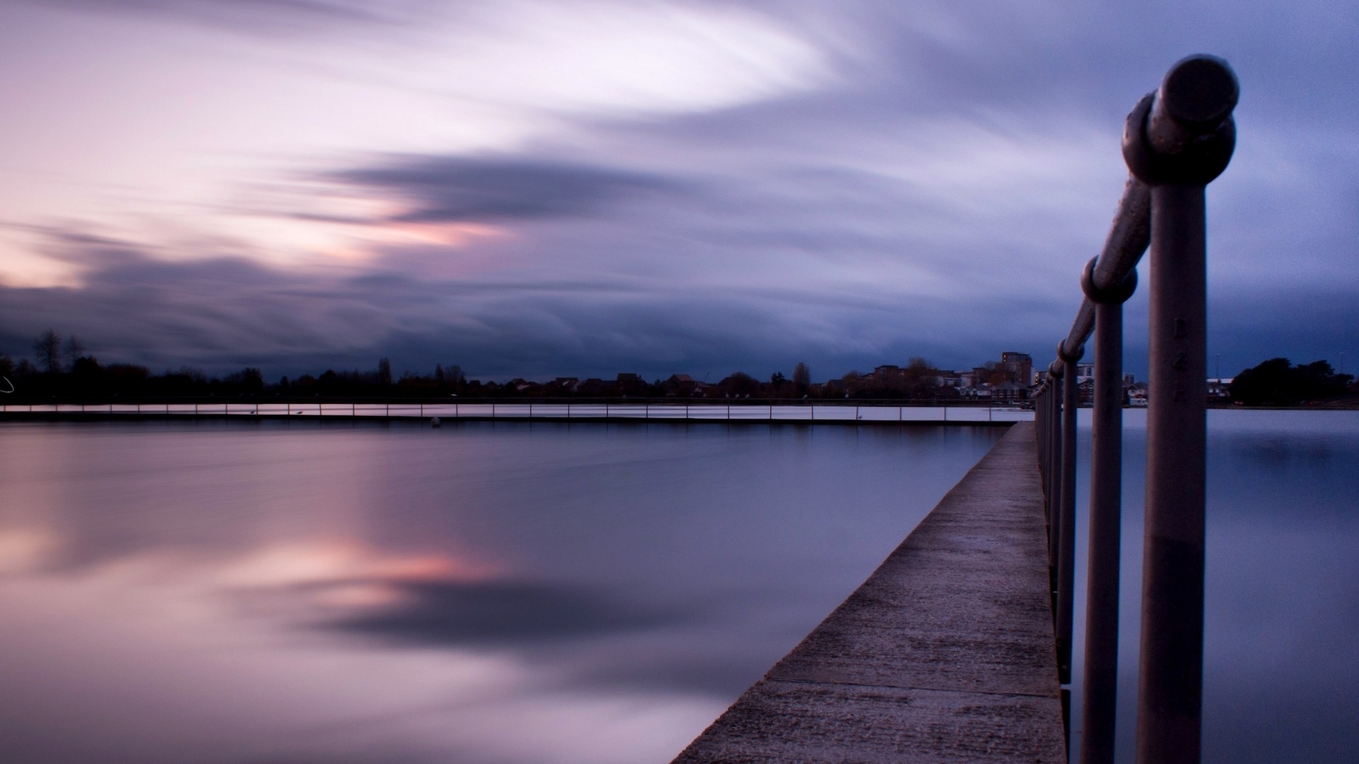 Pier at dusk with cloudy sky