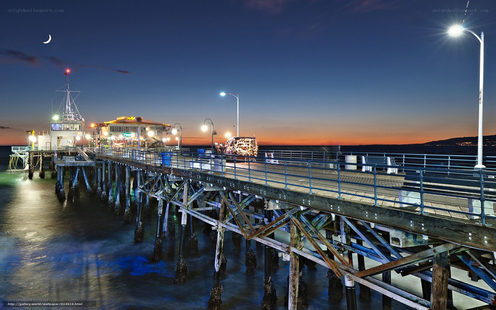 Pier at dusk with crescent moon