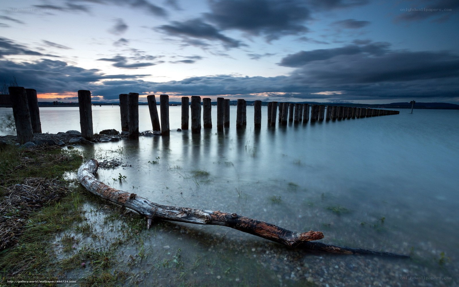 Pier at dusk with driftwood