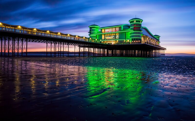 Pier at dusk with green lights