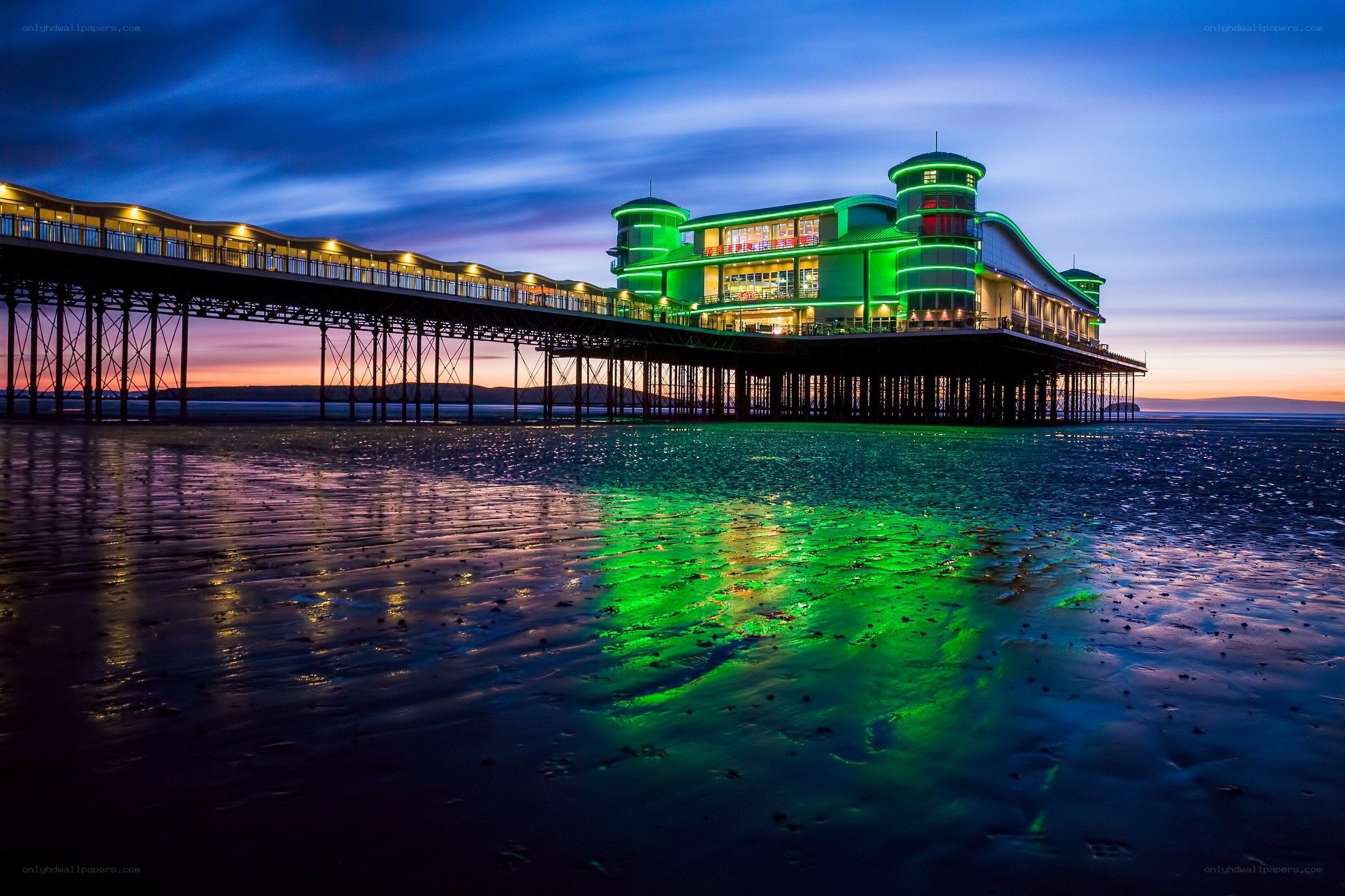 Pier at dusk with green lights