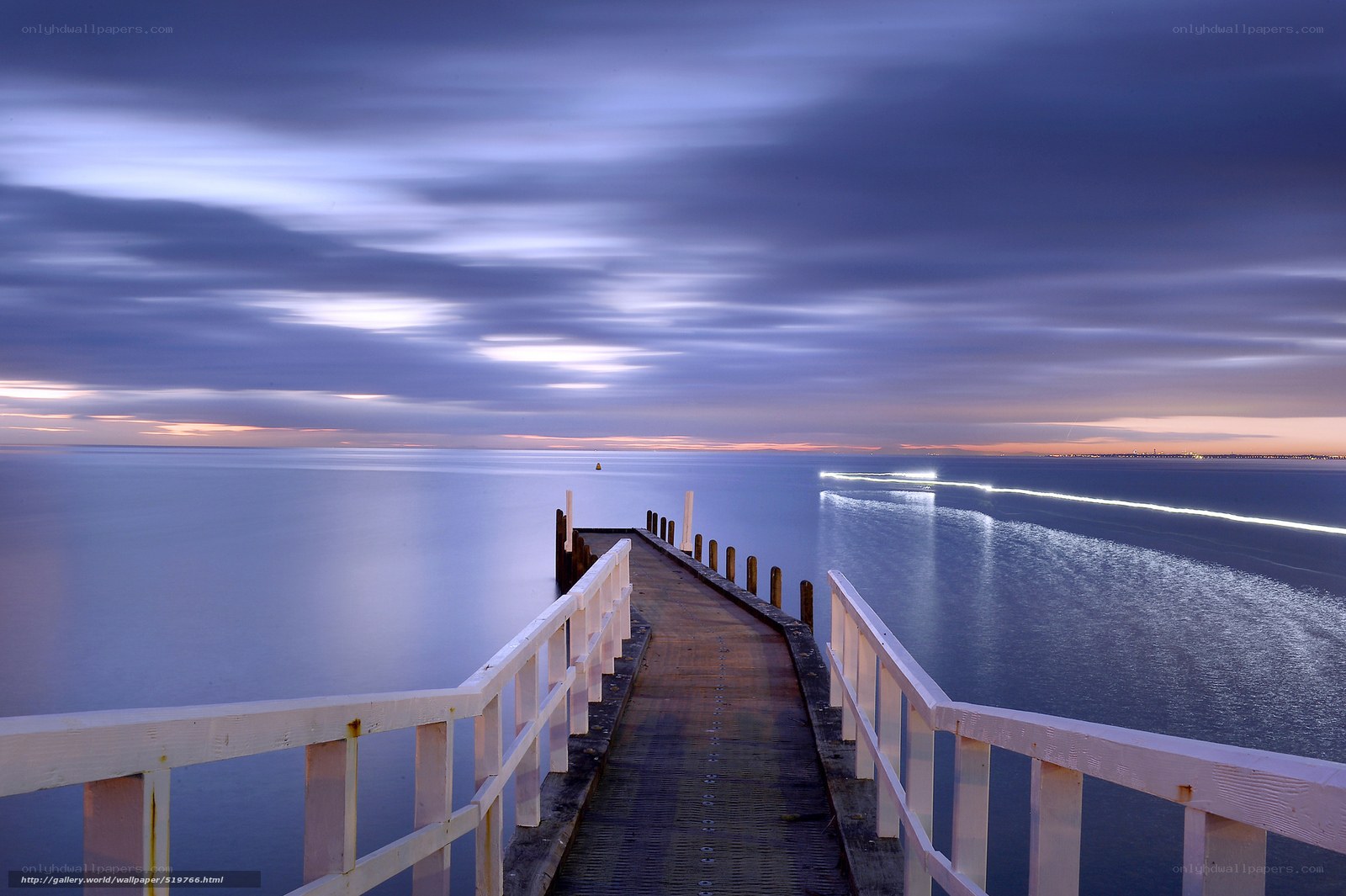 Pier at dusk with light trails