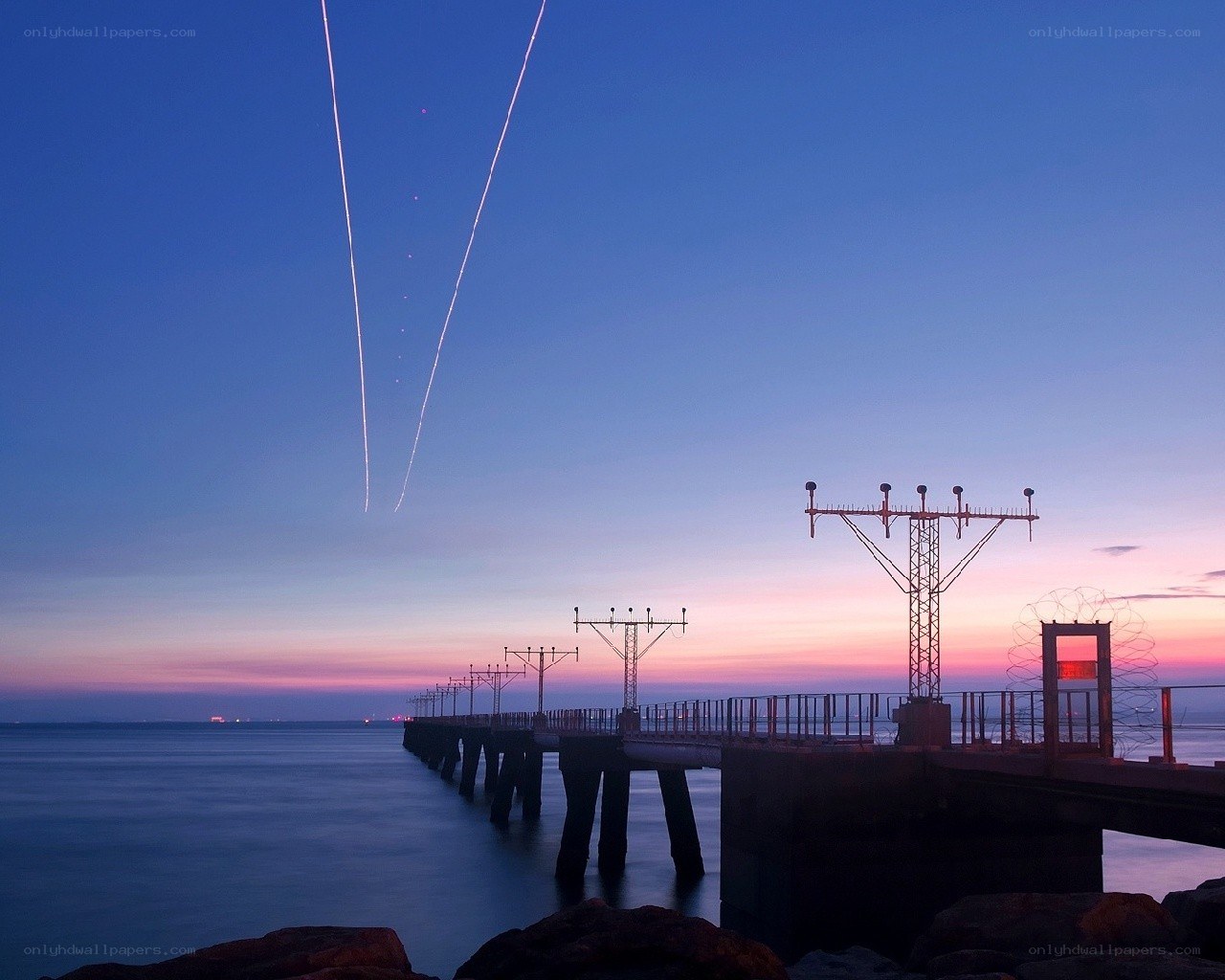 Pier at dusk with light trails