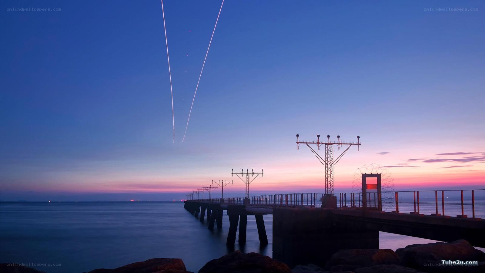 Pier at dusk with light trails