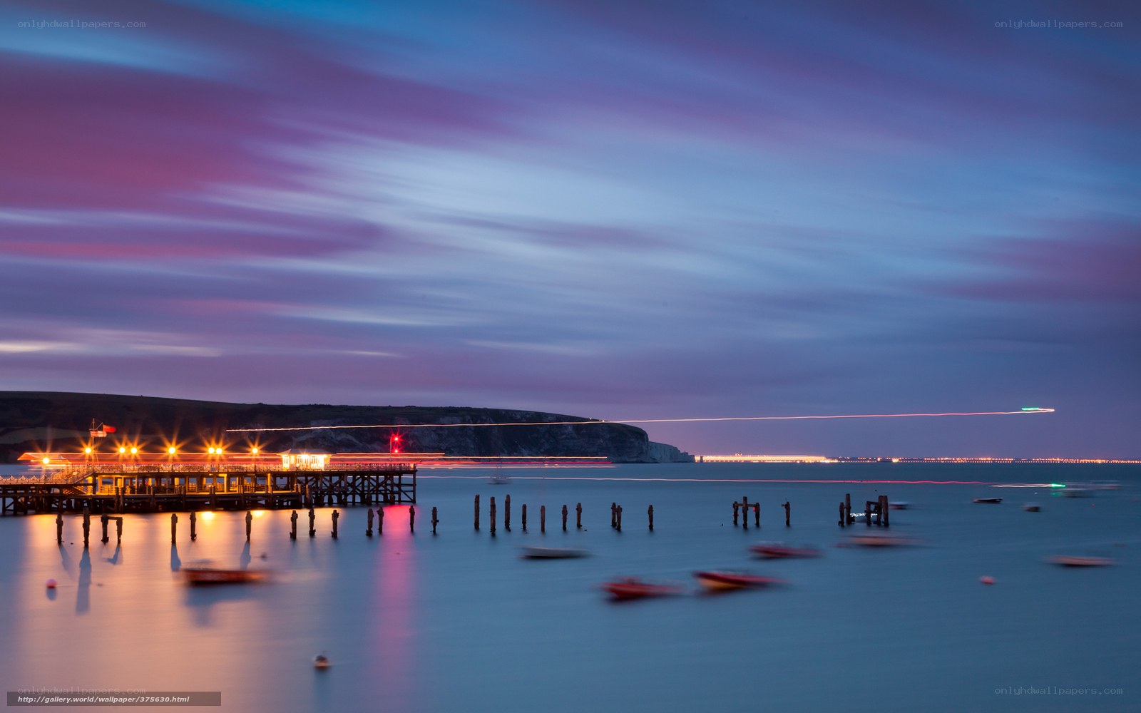 Pier at dusk with light trails