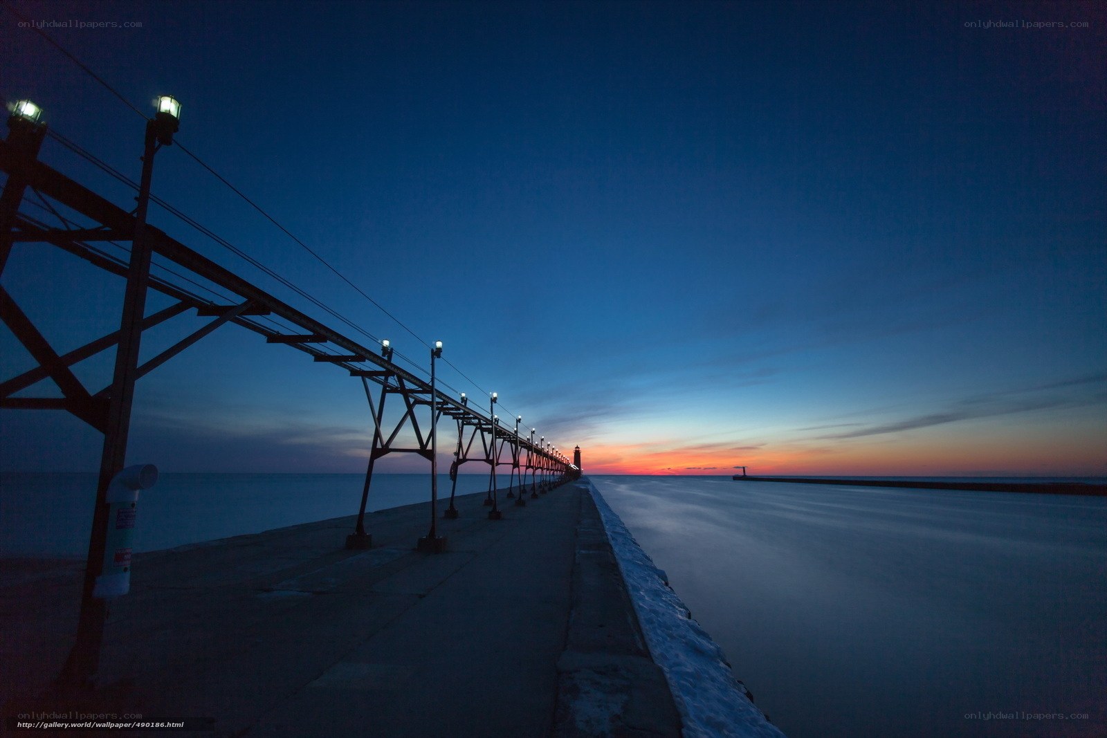 Pier at dusk with lighthouse