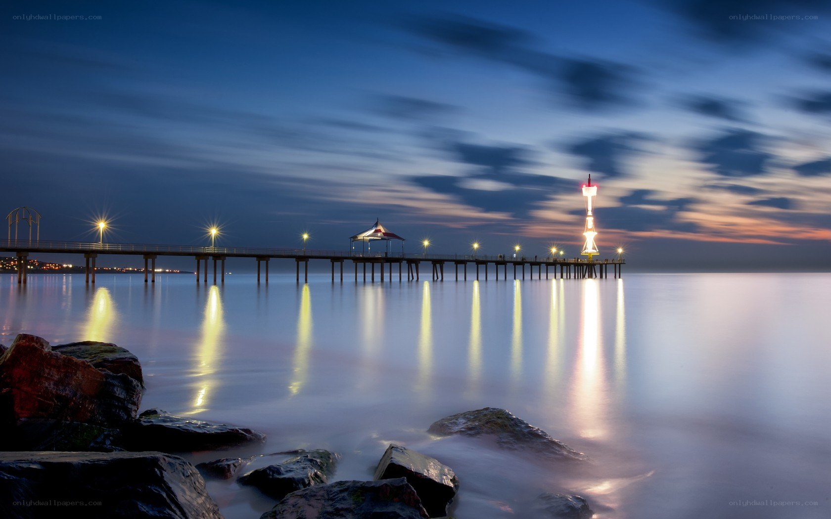 Pier at dusk with lighthouse