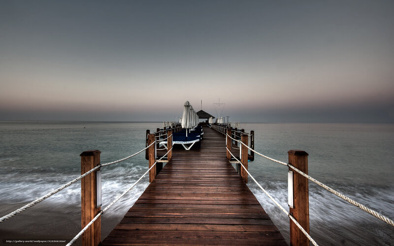 Pier at dusk with lounge chairs