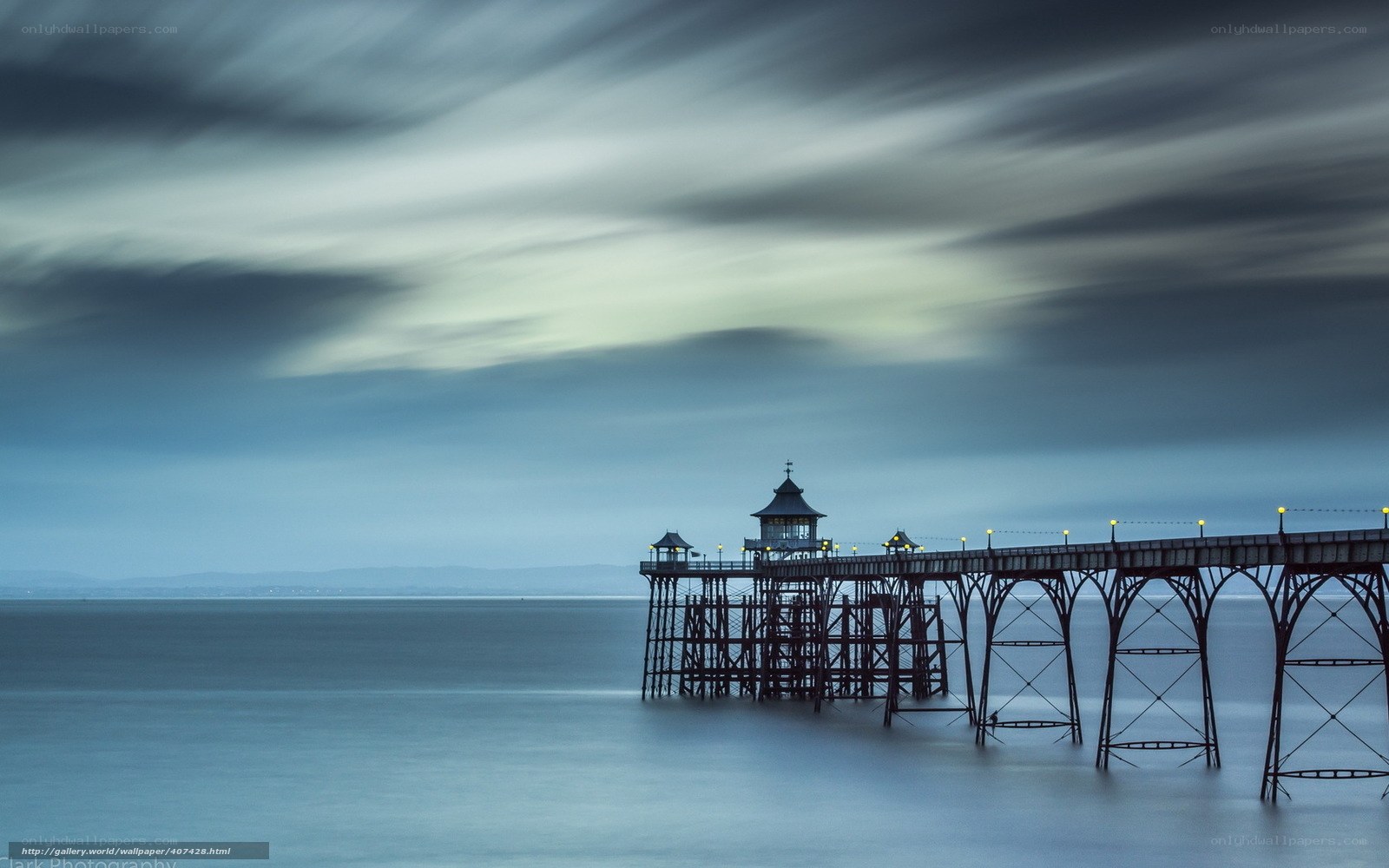 Pier at dusk with motion-blurred sky