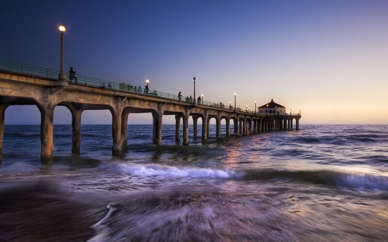 Pier at dusk with ocean waves
