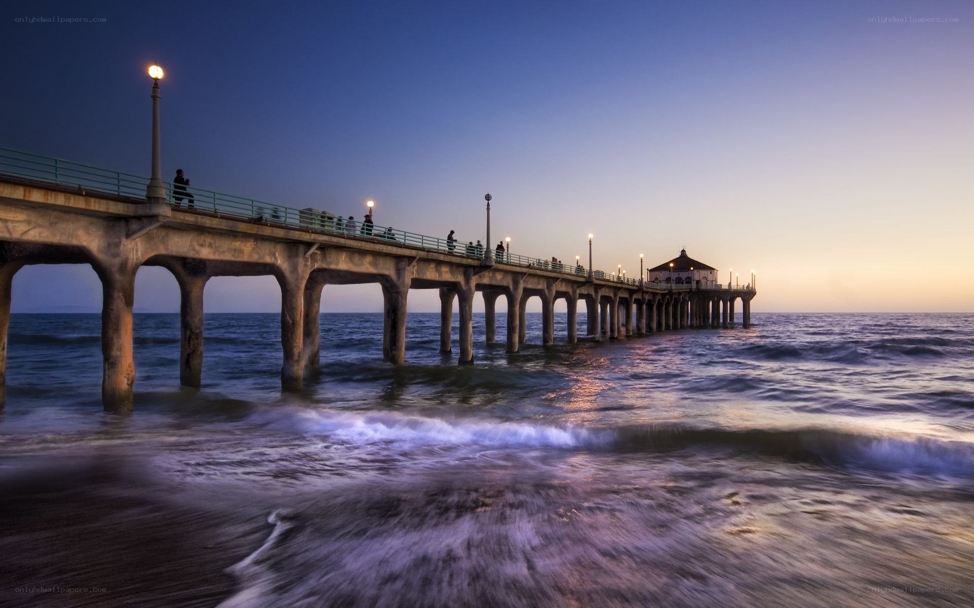 Pier at dusk with ocean waves