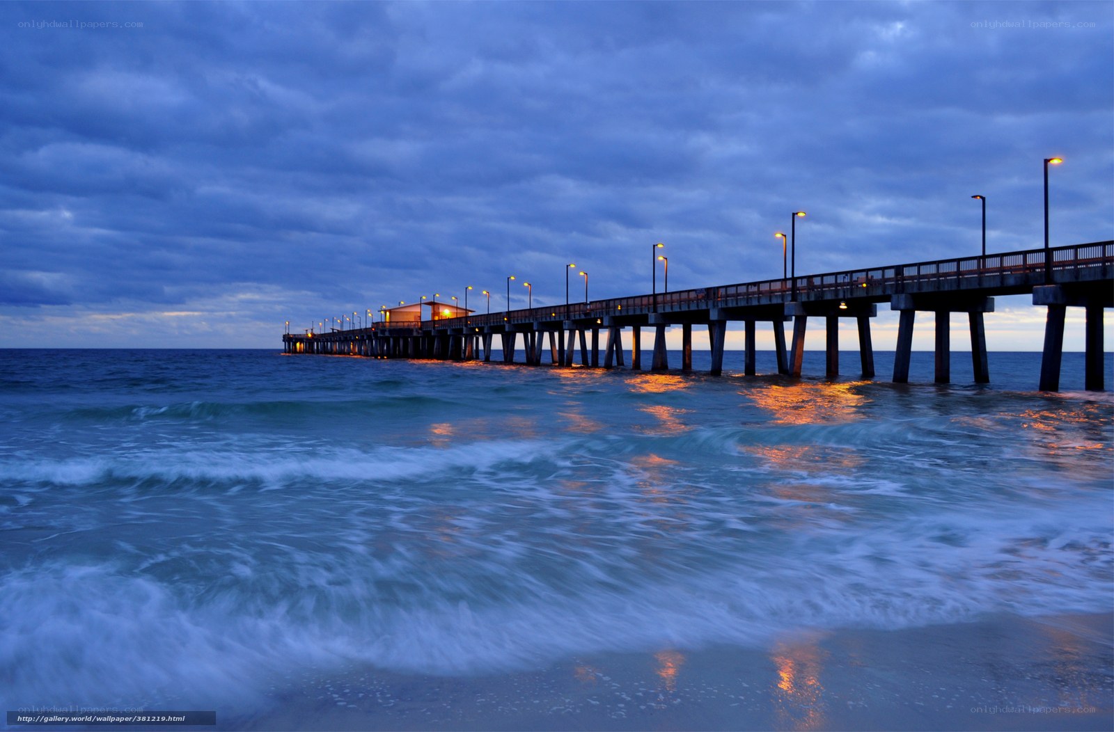 Pier at dusk with ocean waves