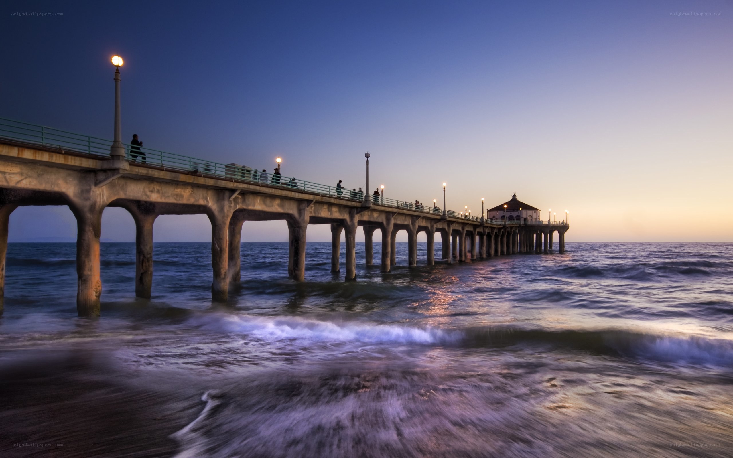 Pier at dusk with ocean waves