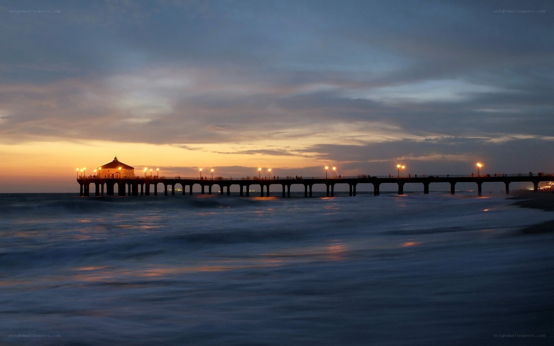 Pier at dusk with ocean waves