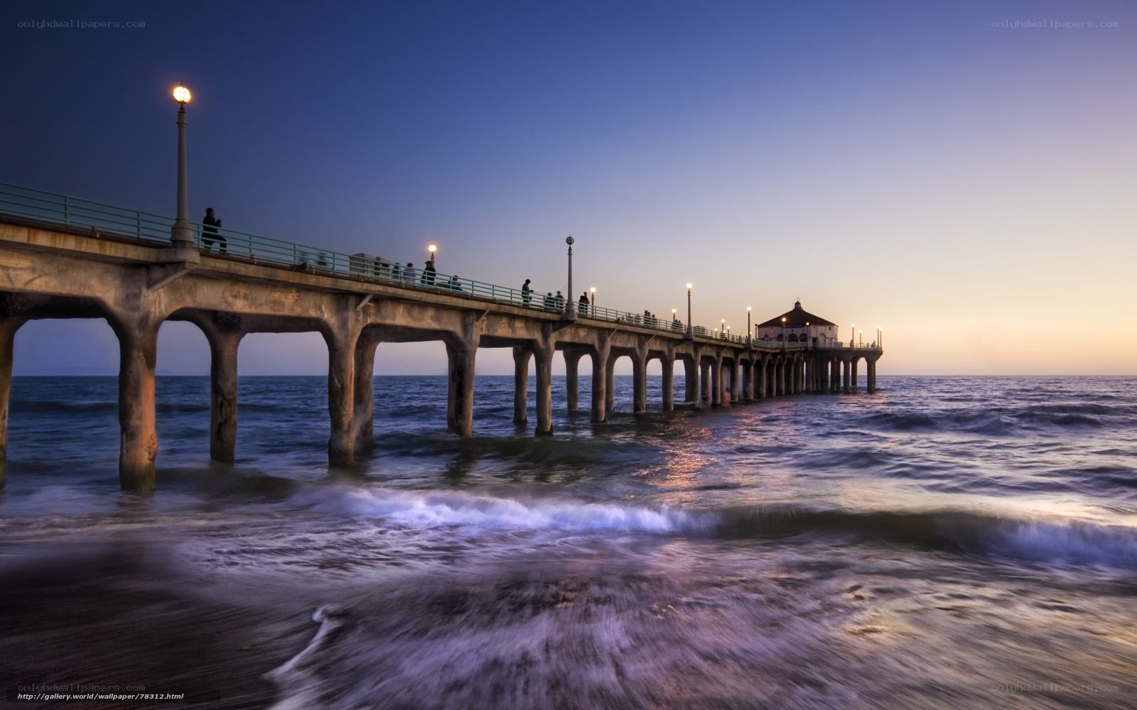 Pier at dusk with ocean waves