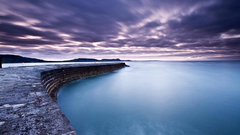 Pier at dusk with purple sky