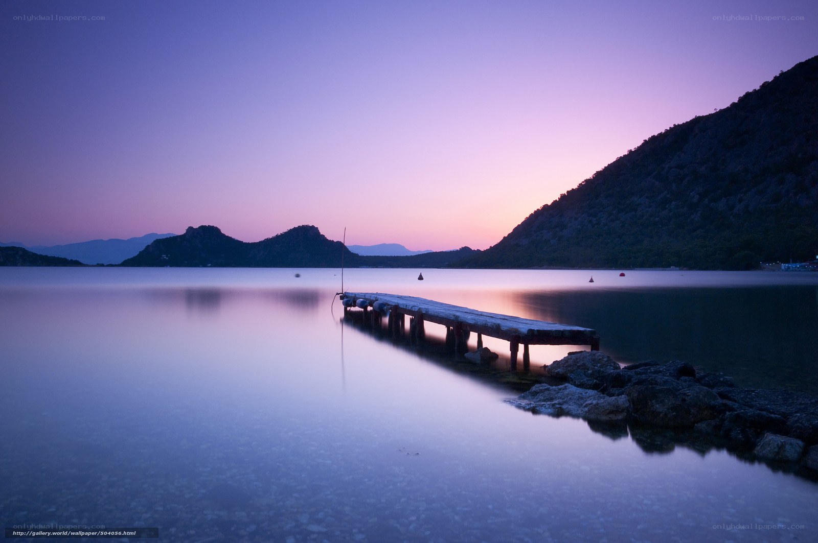 Pier at dusk with purple sky