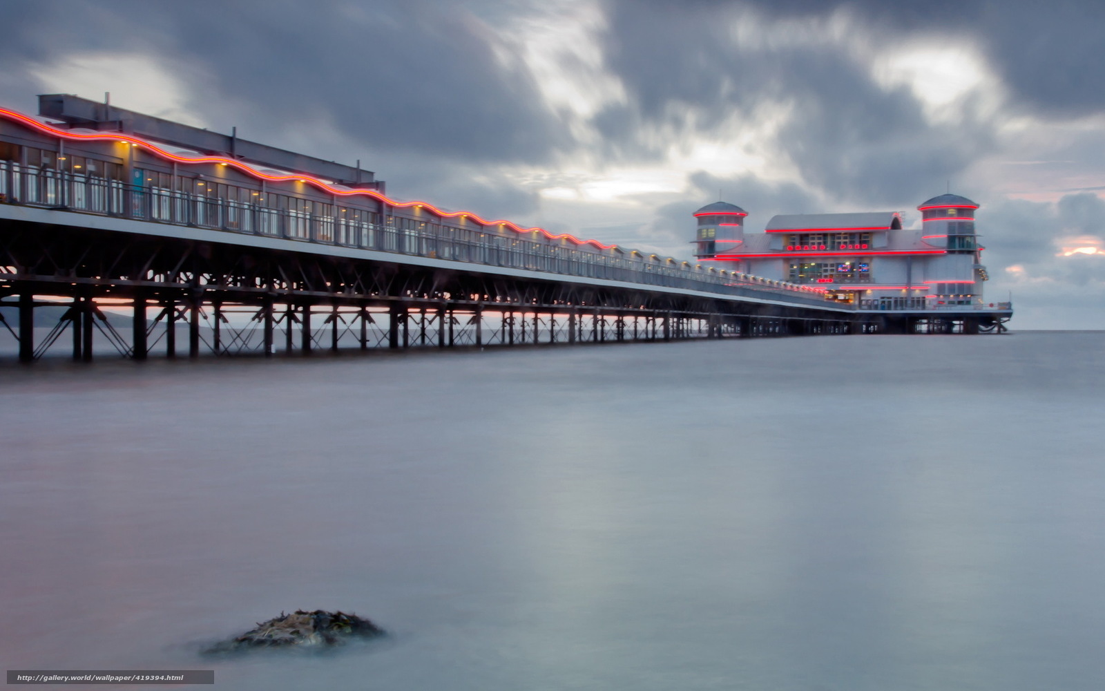 Pier at dusk with red lights