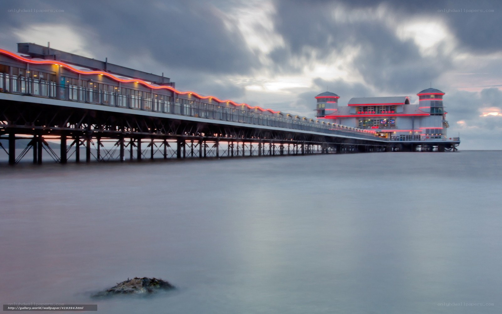 Pier at dusk with red lights